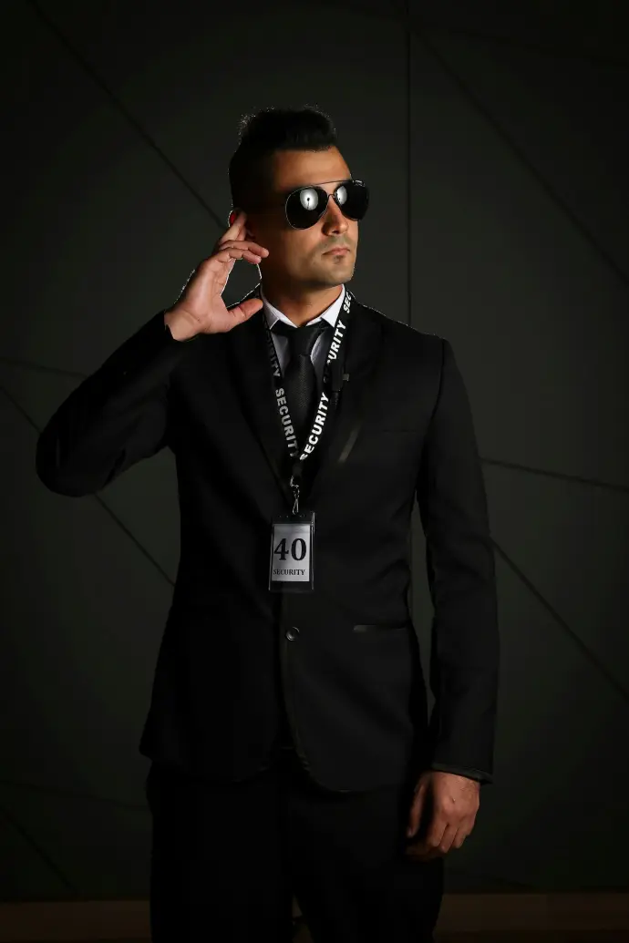 man in black suit wearing black sunglasses